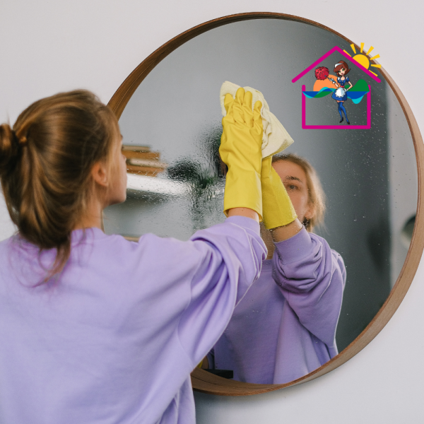 The Maids cleaning round bathroom mirror with cloth